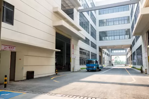 奥斯玛智能装备生产园区内部道路另一视角全景，现代化智能物流通道纵深景观，融合工业美学与生态设计，展现高效制造园区交通动脉的立体脉络